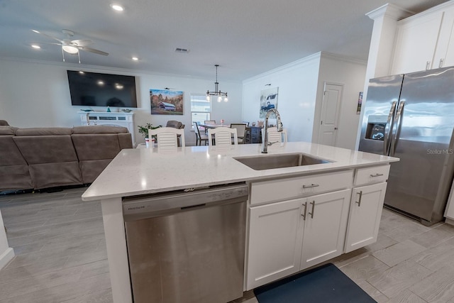 kitchen with sink, white cabinetry, hanging light fixtures, an island with sink, and stainless steel appliances