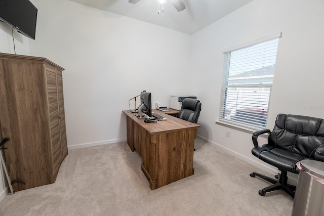 carpeted office space featuring ceiling fan