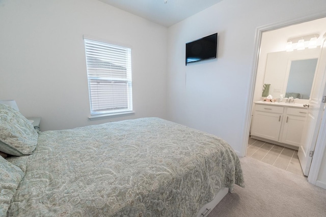 carpeted bedroom with ensuite bath