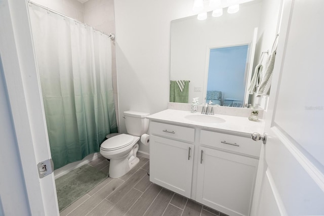 bathroom with a shower with curtain, vanity, and toilet