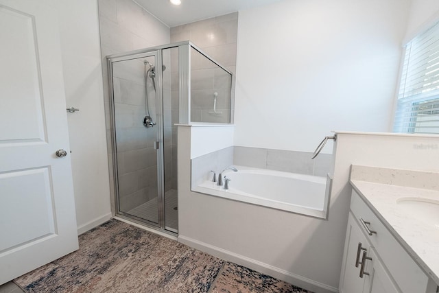 bathroom featuring plus walk in shower and vanity