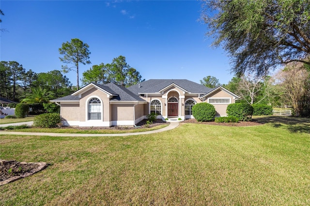 ranch-style house with a garage and a front lawn