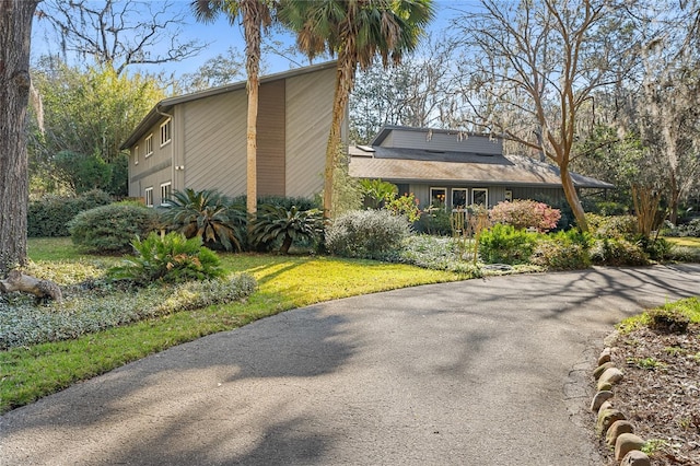 view of side of property with a yard