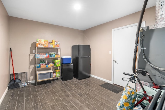 game room featuring wood tiled floor and baseboards