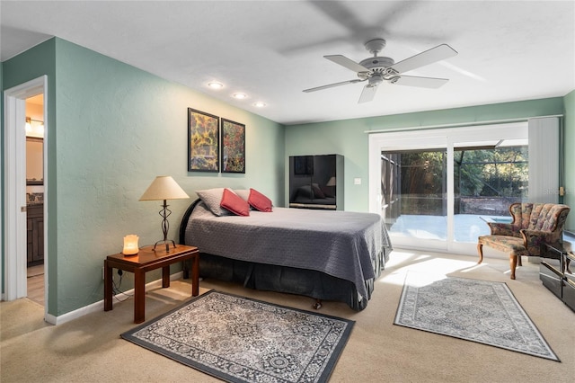 bedroom featuring access to exterior, light colored carpet, a textured wall, a ceiling fan, and baseboards