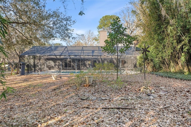 view of yard with glass enclosure