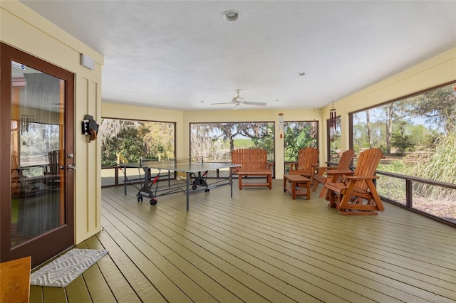 sunroom / solarium featuring ceiling fan and a healthy amount of sunlight