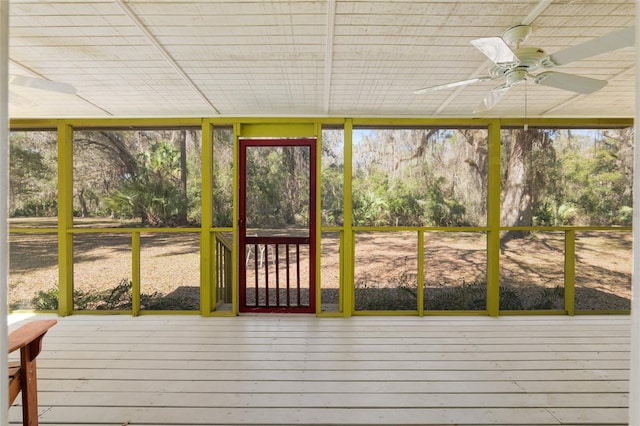 unfurnished sunroom with ceiling fan