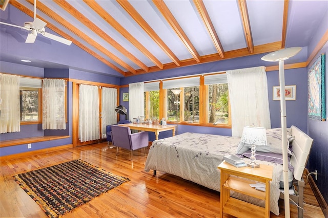 bedroom featuring lofted ceiling with beams and hardwood / wood-style flooring