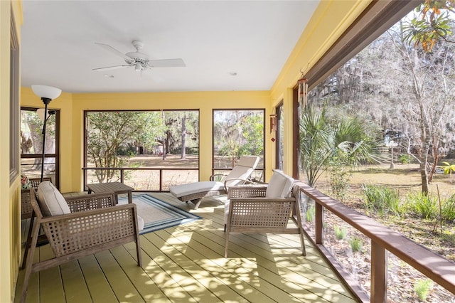 sunroom / solarium featuring ceiling fan