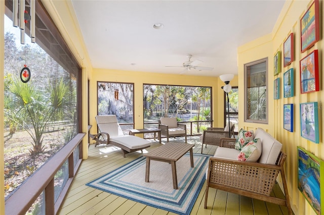 sunroom / solarium featuring ceiling fan