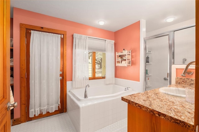 bathroom featuring vanity and shower with separate bathtub