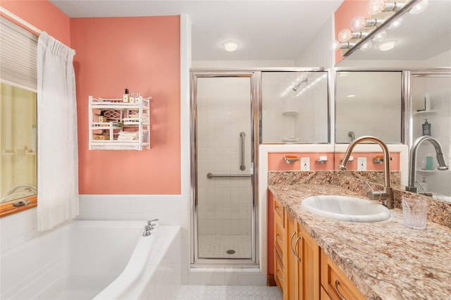 bathroom with vanity, shower with separate bathtub, and tile patterned flooring