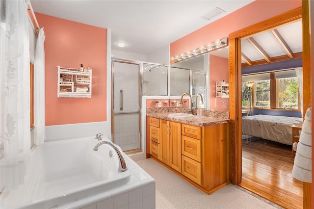 bathroom featuring vanity and separate shower and tub