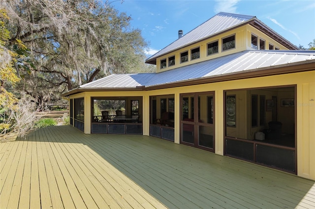 wooden deck featuring a sunroom