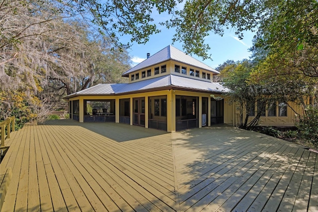 wooden terrace featuring a sunroom