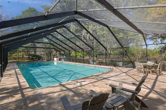 view of swimming pool with a patio and glass enclosure