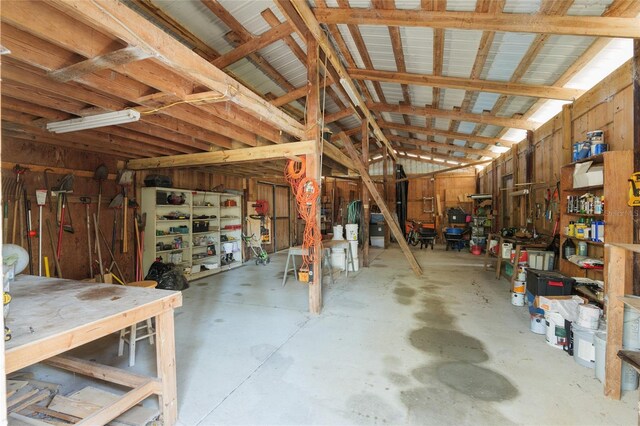 interior space with vaulted ceiling and a workshop area