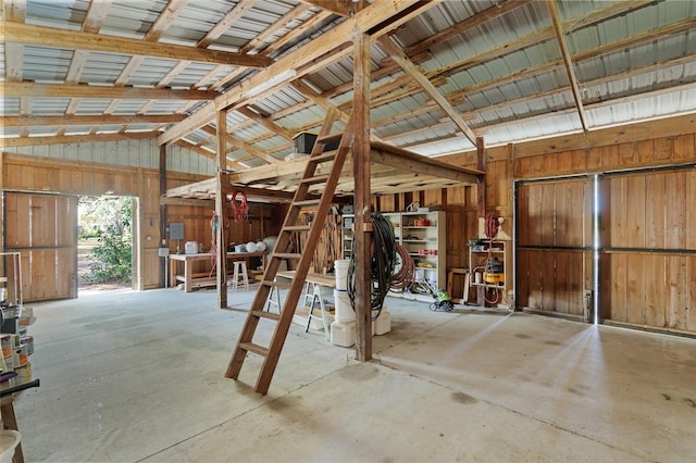 miscellaneous room with vaulted ceiling and concrete flooring