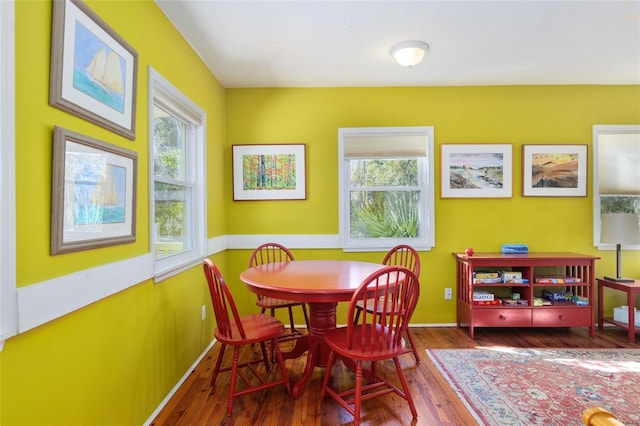 dining space with wood-type flooring