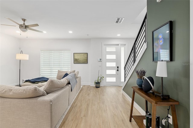 living room featuring ceiling fan and light wood-type flooring