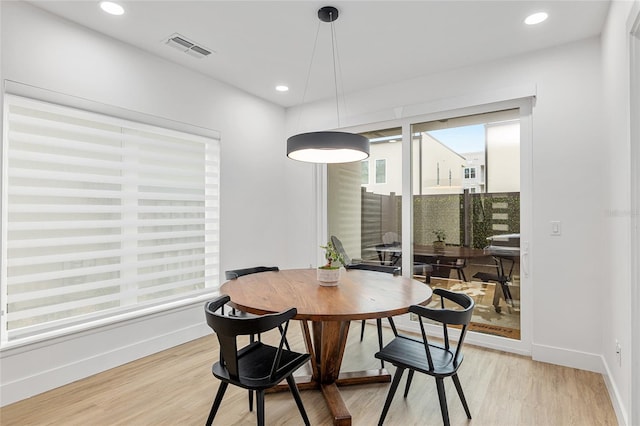 dining space with light hardwood / wood-style floors