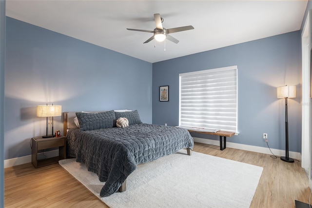 bedroom with hardwood / wood-style floors and ceiling fan