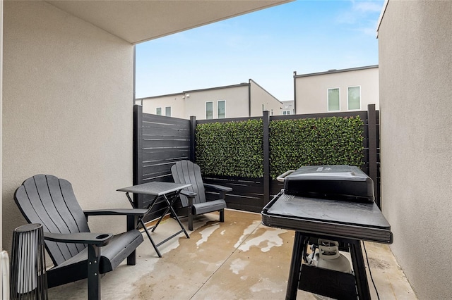 view of patio featuring a balcony and grilling area