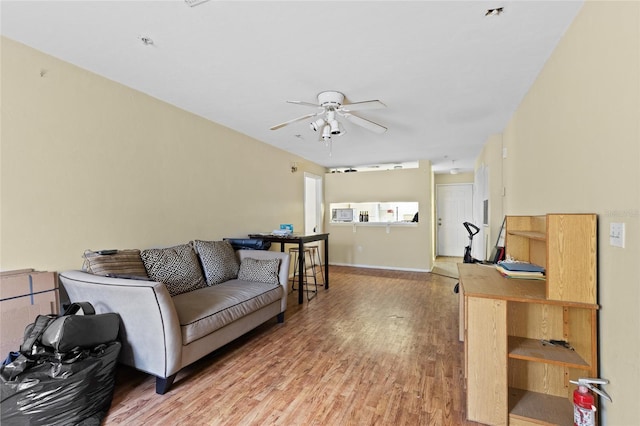 living room with ceiling fan and wood-type flooring