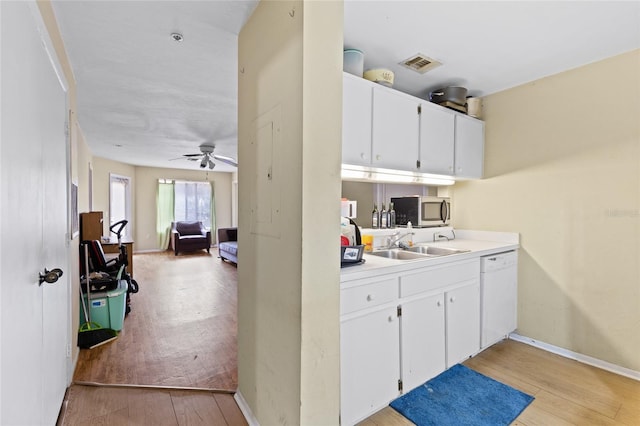 kitchen featuring white cabinetry, sink, ceiling fan, white dishwasher, and light hardwood / wood-style flooring