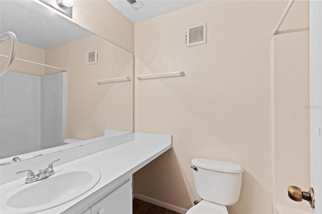 bathroom with vanity, toilet, and walk in shower