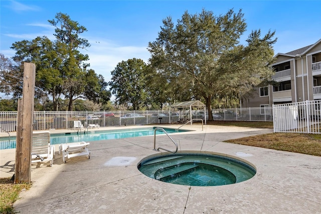 view of swimming pool featuring a community hot tub and a gazebo