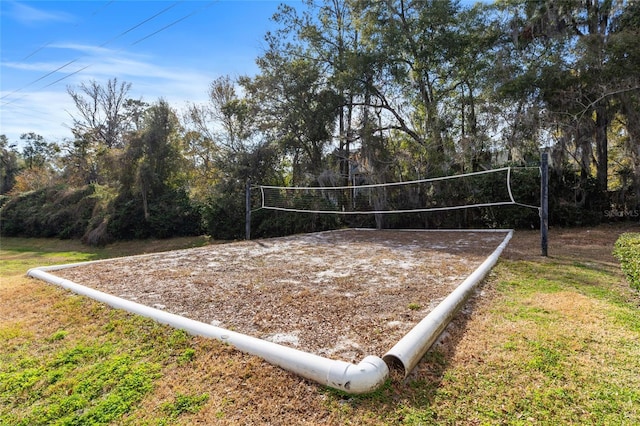 view of home's community featuring volleyball court and a lawn