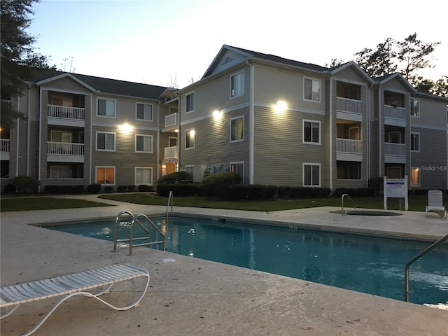 view of pool at dusk