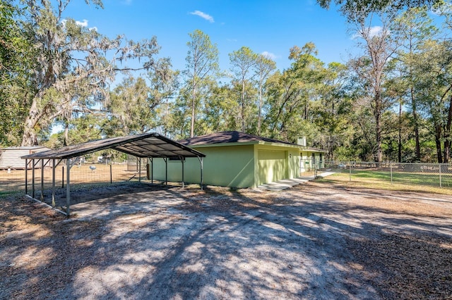 view of side of property with a carport