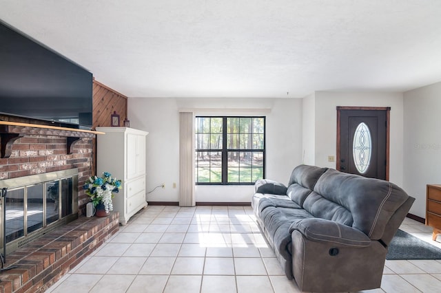 tiled living room featuring a brick fireplace and wood walls