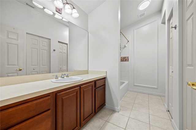 bathroom featuring tile patterned flooring, vanity, and bathing tub / shower combination