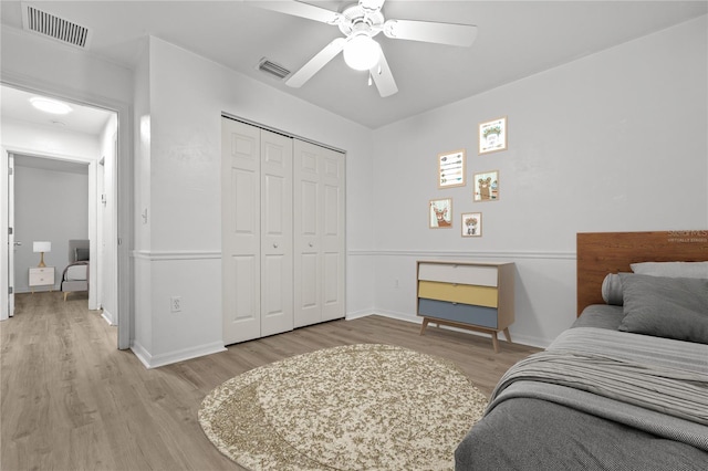 bedroom with ceiling fan, a closet, and light hardwood / wood-style flooring