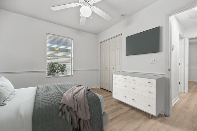 bedroom with light hardwood / wood-style floors, a closet, and ceiling fan