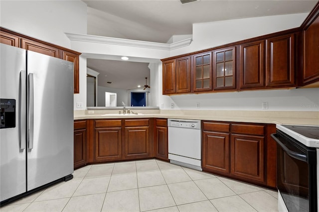 kitchen with light tile patterned flooring, sink, electric range, stainless steel fridge, and white dishwasher