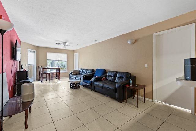 tiled living room with ceiling fan and a textured ceiling