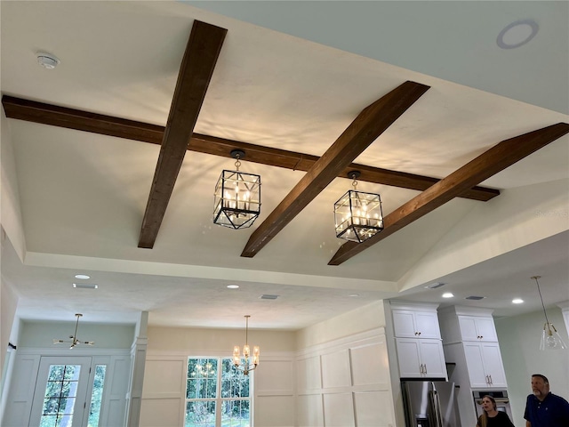 room details with an inviting chandelier, stainless steel fridge with ice dispenser, and beamed ceiling