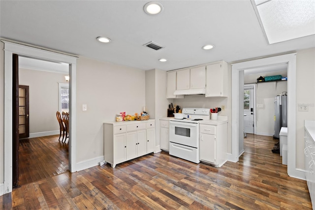 kitchen featuring white cabinetry, dark hardwood / wood-style flooring, white electric stove, and refrigerator