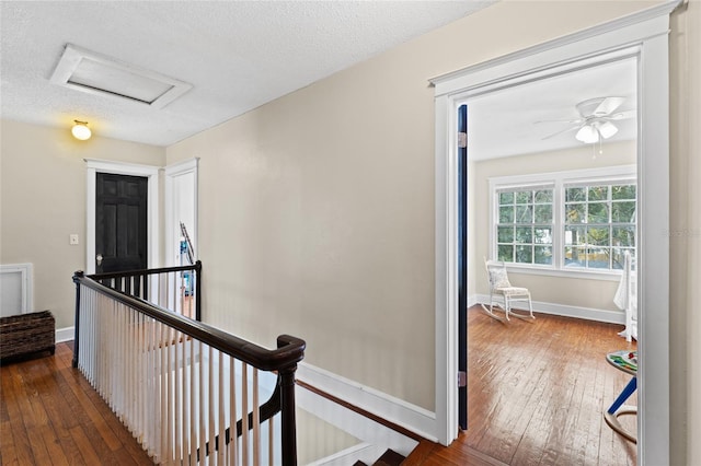 corridor featuring dark hardwood / wood-style floors and a textured ceiling