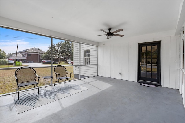 sunroom / solarium featuring ceiling fan