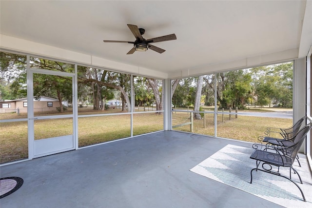 unfurnished sunroom featuring ceiling fan