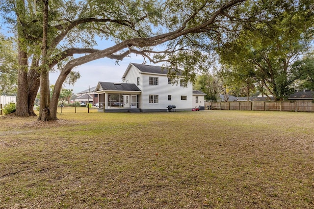 back of house featuring a lawn