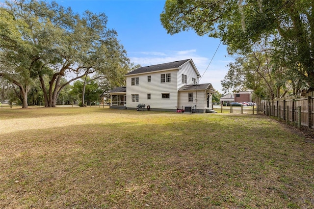 back of property featuring a yard and central AC unit