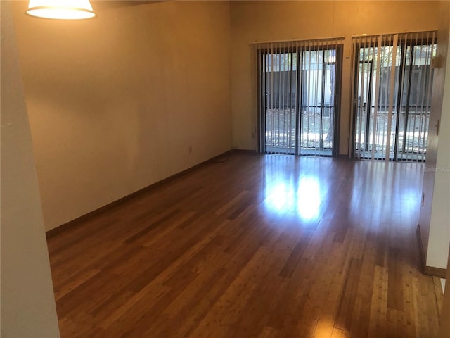 empty room featuring dark hardwood / wood-style flooring