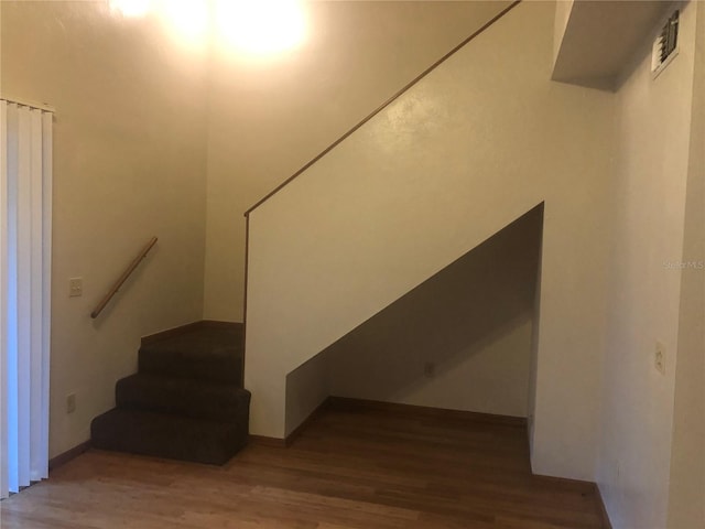 staircase with hardwood / wood-style flooring